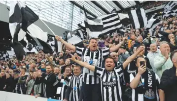  ?? VNA Photo
AFP/ ?? HA'WAY THE LADS: Newcastle United fans with flags during the Premier League match between Newcastle United and Leicester City at St. James Park on Monday. Newcastle qualified for the Champions League for the first time in 20 years after a 0-0 draw against relegation­haunted Leicester.