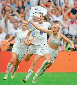  ?? AFP ?? England striker Chloe Kelly (right) takes off her shirt as she celebrates scoring the winning goal against Germany at the Wembley Stadium in London on Sunday. —