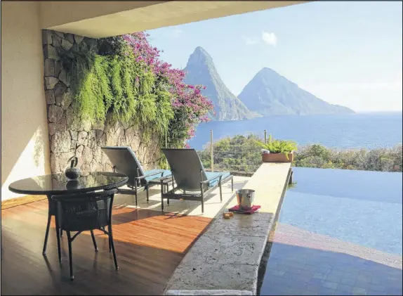  ?? CONTRIBUTE­D PHOTOS BY WESLEY K.H. TEO ?? At Jade Mountain, a luxury resort in St. Lucia, suites have no fourth wall and are open to a view of the Pitons.