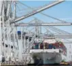  ?? THE ASSOCIATED PRESS ?? Georgia Ports Authority’s ship-toshore cranes begin work offloading cargo from the Cosco Developmen­t container ship at the Port of Savannah on Thursday in Garden City, Ga.