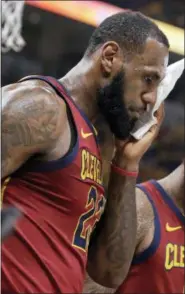  ?? DARRON CUMMINGS — THE ASSOCIATED PRESS ?? Cleveland Cavaliers’ LeBron James holds a cloth to a cut above his eye after being injured on a drive to the basket during the first half of Game 6 of a first-round NBA basketball playoff series against the Indiana Pacers, Friday in Indianapol­is.