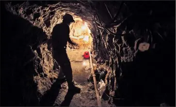  ?? Peggy Peattie San Diego Union- Tribune ?? LANCE LENOIR of the Border Patrol’s Tunnel Rat team walks in the Galvez tunnel, a path between the U. S. and Mexico in Otay Mesa. It was built to transport marijuana into a warehouse but was never used.