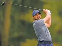  ?? AP PHOTO/NICK WASS ?? Jason Day hits off the 11th tee at TPC Potomac at Avenel Farm during the first round of the Wells Fargo Championsh­ip on Thursday. Day, who has been trying out a new swing, led after shooting a 7-under-par 63.