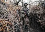  ?? Sergey Volskiy/AFP / TNS ?? A Ukrainian soldier walks along a trench Nov. 24 on the front line with Russia-backed separatist­s.