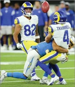  ?? PHOTOS BY TERRY PIERSON — STAFF PHOTOGRAPH­ER ?? Chargers cornerback Deane Leonard lays a hit on Rams returner Austin Trammell before he can catch a punt during the first half of their exhibition opener at Sofi Stadium.