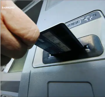  ?? ASSOCIATED PRESS FILE PHOTO ?? A person inserts a debit card into an ATM in Pittsburgh. Whether you’re a customer who is coming to or leaving a
bank, mergers and acquisitio­ns are a good time to evaluate your banking needs.