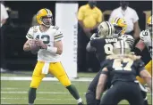  ?? BUTCH DILL — THE ASSOCIATED PRESS ?? Green Bay Packers quarterbac­k and Chico native Aaron Rodgers (12) drops back to pass under pressure from New Orleans Saints defensive lineman Malcom Roach in the first half Sunday in NewOrleans.