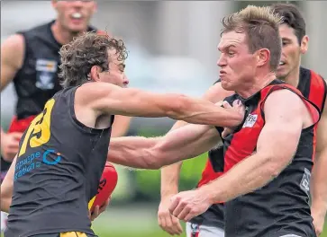  ?? Pictures: Bruce Povey ?? Rochester’s Nick O’Connor, playing his 100th senior game, gets up close and personal with Kyabram gun Jordan Williams.