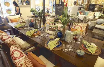  ??  ?? TV host Christine Jacob-Sandejas’ colorful outdoor table uses all-melamine dinnerware and glasses by Pottery Barn, matched with summer-print pillows.