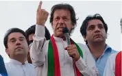  ??  ?? Imran Khan ( centre) addresses supporters outside the Parliament building in Islamabad on Sunday. —