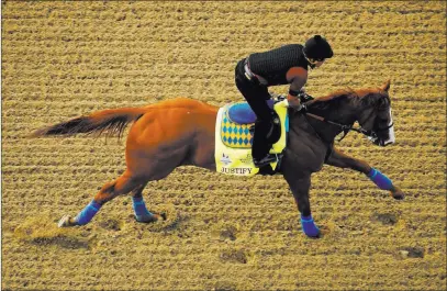  ?? Charlie Riedel ?? The Associated Press Early Kentucky Derby favorite Justify glides through a Wednesday morning workout at Churchill Downs in Louisville, Ky.