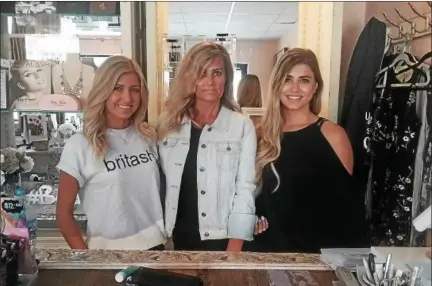  ?? JEAN BONCHAK FOR THE NEWS-HERALD ?? Brittanie Olson, left, and Ashleigh Olson stand on either side of their mother Christie Olson. The family recently started a new beauty and fashion business in Mentor.