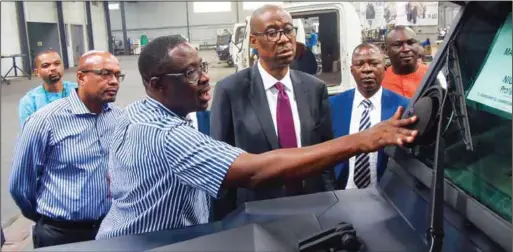  ??  ?? MD/CEO of PROFORCE, Mr. Ade Ogundeyin, showcasing one of the armoured vehicles the company locally produced to the Minister of Industry, Trade and Investment, Dr. Okechukwu Enelamah, during the minister’s tour of Industries at Ode Remo in Ogun State…...