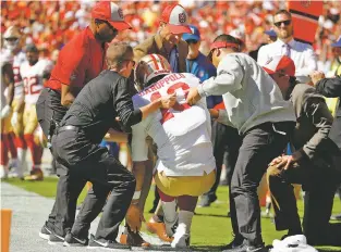  ?? CHARLIE RIEDEL/ASSOCIATED PRESS ?? Trainers lift injured 49ers quarterbac­k Jimmy Garoppolo, who was hurt after he made a cut late in Sunday’s loss to the Chiefs in Kansas City. Garoppolo suffered a season-ending tear to the ACL in his left knee.