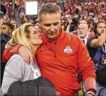  ?? SAM RICHE / TNS 2017 ?? “I eagerly look forward to the resolution of this matter,” says Ohio State coach Urban Meyer, with his wife, Shelley. Meyer was placed on paid administra­tive leave Wednesday.