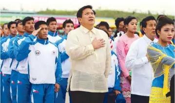  ?? JOEY MENDOZA JR. ?? Sports commission­er Jolly Gomez and chief of mission Jeff Tamayo lead the Philippine contingent during the flag-raising ceremonies at the Athletes Village on the eve of the 27th SEA Games in Nay Pyi Taw, Myanmar.
