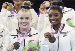  ?? GEERT VANDEN WIJNGAERT — THE ASSOCIATED PRESS ?? United States’ Simone Biles, right, holds her gold medal as she celebrates with her injured teammate Joscelyn Roberson, left, after the women’s team final at the Artistic Gymnastics World Championsh­ips in Antwerp, Belgium, on Wednesday.