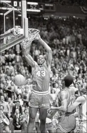  ??  ?? North Carolina State’s Lorenzo Charles dunks the ball to give N.C. State a 54-52, buzzer-beating win over Houston in the NCAA Final Four championsh­ip game.