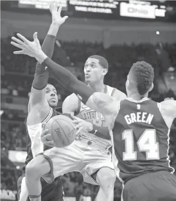  ?? ASSOCIATED PRESS ?? Cleveland Cavaliers' Jordan Clarkson, center, drives to the basket against San Antonio Spurs' LaMarcus Aldridge, left, and San Antonio Spurs' Danny Green in the second half of an NBA basketball game in Cleveland. The Spurs won 110-94.