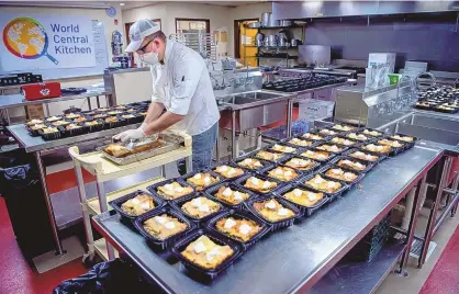  ?? EDDIE MOORE/JOURNAL ?? Working with World Central Kitchen, Chef Rocky Durham serves red chile chicken enchiladas for more than 300 people in the culinary department at Santa Fe Community College on April 30, 2020. Aid workers prepared an estimated 53,000 meals during the COVID-19 pandemic.