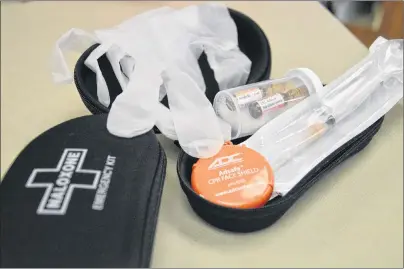  ?? NIKKI SULLIVAN/CAPE BRETON POST ?? A naloxone kit has everything you need to help someone who is suffering from an opioid overdose. Inside are a pair of protective gloves, a protective mask, two shots of the drug, and a needle for injecting into the thigh. Training must be done before...