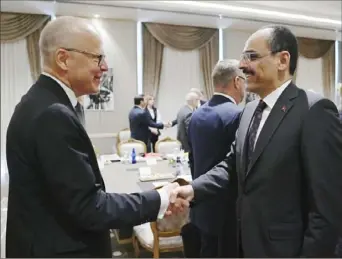  ?? Turkish Presidency via AP ?? Ibrahim Kalin, right, spokesman of President Recep Tayyip Erdogan, welcomes Swedish State Secretary Oscar Stenstroem on Wednesday before a meeting with their delegation­s in Ankara, Turkey.