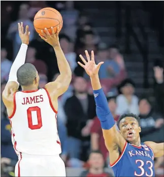  ?? Oklahoma's Christian James shoots over Kansas's David McCormack during Tuesday night's game in Norman. [SARAH PHIPPS/THE OKLAHOMAN] ??