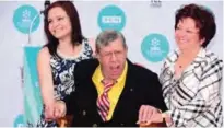  ??  ?? This file photo taken on April 12, 2014 shows US comedian Jerry Lewis (center) posing with his wife SanDee Pitnick (right) and daughter Danielle (left) at his Hand and Footprint ceremony at the TCL Theater in Hollywood, California.