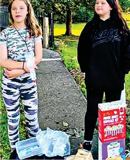  ?? ?? Caring: Lacey, left, and Connie holding charity sale before horror