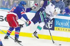  ?? FRANK FRANKLIN II/AP ?? Rangers blue-liner Brady Skjei checks Bo Horvat during action Monday in New York. The Rangers won 2-1.