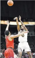  ?? Hans Pennink ?? The Associated Press Iona guard Zach Lewis shoots over Fairfield guard Jerome Segura in the second half of the Gaels’ 83-71 win Monday.