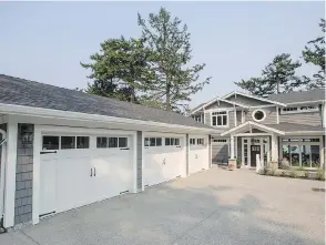  ??  ?? A triple garage appears larger than it is, thanks to barn-style doors. The shingle-style house has an attractive covered entry and the garages are not front and centre, the designer notes.