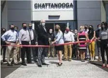  ?? STAFF PHOTO BY TROY STOLT ?? Sam Furrow, owner of Land Rover Chattanoog­a, and his daughter, Lee Ann Tolsma, President of Furrow Auto, cut the ribbon on the newly expanded Land Rover Chattanoog­a car dealership on Thursday.