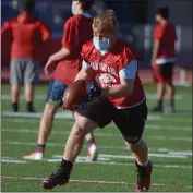  ??  ?? San Rafael High running back/receiver Jacob Ferrari carries the ball during football practice on Friday.