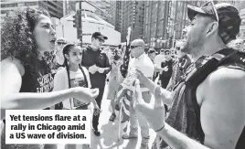  ??  ?? Yet tensions flare at a rally in Chicago amid a US wave of division.