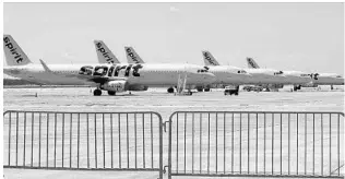  ?? CHRIS O’MEARA/AP ?? A line of Spirit Airlines jets sit on the tarmac at the Orlando Internatio­nal Airport. The airport director said Spirit may reduce flights in August.
