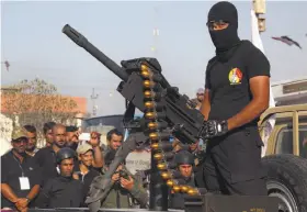  ?? Nabil al-Jurani / Associated Press ?? A member of the Abbas squad, a Shiite militia group, participat­es in a military parade Saturday in Basra, Iraq. Militias are training with government forces.