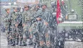  ?? AP PHOTO ?? Army personnel take up position as it snows at the site where two gunmen opened fire near a paramilita­ry camp in Srinagar on Monday.
