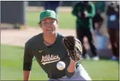  ?? JOHN MEDINA — BAY AREA NEWS GROUP ?? Oakland A's pitcher Shintaro Fujinami participat­es in drills during the Oakland A's first day of Spring Training workouts at Hohokam Stadium on Wednesday in Mesa, Ariz.