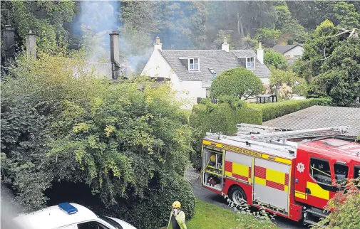  ??  ?? INQUIRIES ONGOING: Firefighte­rs deal with the house blaze on Island Bank Road in Inverness, which erupted at about 1.55am yesterday