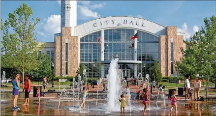  ?? CONTRIBUTE­D BY CITY OF SUWANEE PHOTOS ?? Just another day of playing in the Big Splash fountain. Located in front of Suwanee City Hall, it anchors one end of Town Center Park.