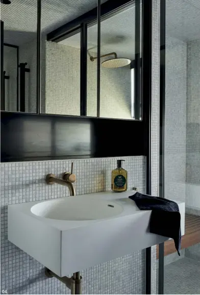  ??  ?? 04 Clad in tiles with subtle colour variation, the guest bathroom provides a touch of luxury.
