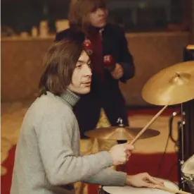  ?? ?? Charlie Watts (with Brian Jones in the background) rehearsing for the Rolling Stones’ Rock and Roll Circus gig, London, December 1968. Photograph: Rolls Press/Popperfoto/Getty Images