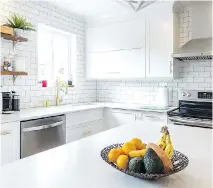  ??  ?? Gagnon installed the backsplash in the kitchen. The couple also had designer Valérie St-André help with the details when redoing their kitchen.