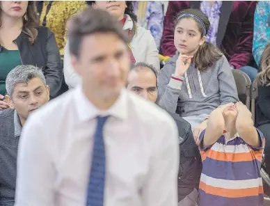  ?? ANDREW VAUGHAN / THE CANADIAN PRESS ?? A young boy reacts during a town-hall meeting with Prime Minister Justin Trudeau in Fredericto­n, N.B., Tuesday. The prime minister remains firmly embedded as Canada’s nice-guy-in-chief, opting to express empathy when faced with a tough question, which often results in a word salad that makes him sound glib, Michael Den Tandt writes.