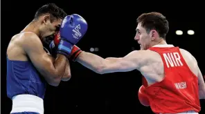  ?? ?? FAMILY DOUBLE: Northern Ireland’s Aidan Walsh [right] triumphs against Englishman Harris Akbar, before his sister Michaela also wins