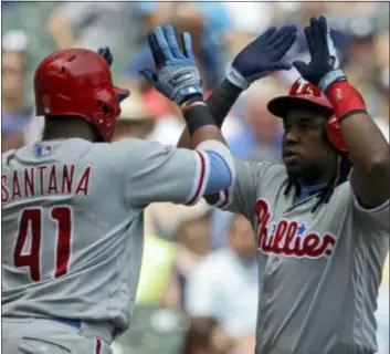  ?? AARON GASH — THE ASSOCIATED PRESS ?? Philadelph­ia’s Maikel Franco celebrates with Carlos Santana after hitting a two-run home run Sunday against the Brewers.