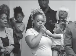  ?? CURTIS COMPTON/ATLANTA JOURNAL-CONSTITUTI­ON ?? Tomika Miller, the wife of Rayshard Brooks, holds their daughter Memory, 2, gently kissing her hand during the family press conference on Monday in Atlanta. Brooks was killed by an Atlanta Police Department officer Friday.