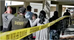  ?? AP ?? Family members are led into the Thousand Oaks Teen Centre where families have gathered after a deadly shooting at a bar on Thursday in Thousand Oaks, California.