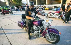  ??  ?? A member of a biker gang
rides a Harley Davidson motorcycle as others show off their machines during the annual Baghdad Summer
Festival.